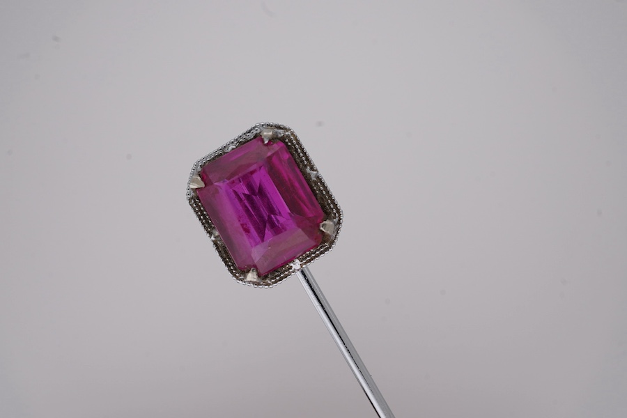 A North American? 10k white metal and single stone emerald cut synthetic ruby set stick pin, 55mm, gross weight 1.1 grams. Condition - fair to good